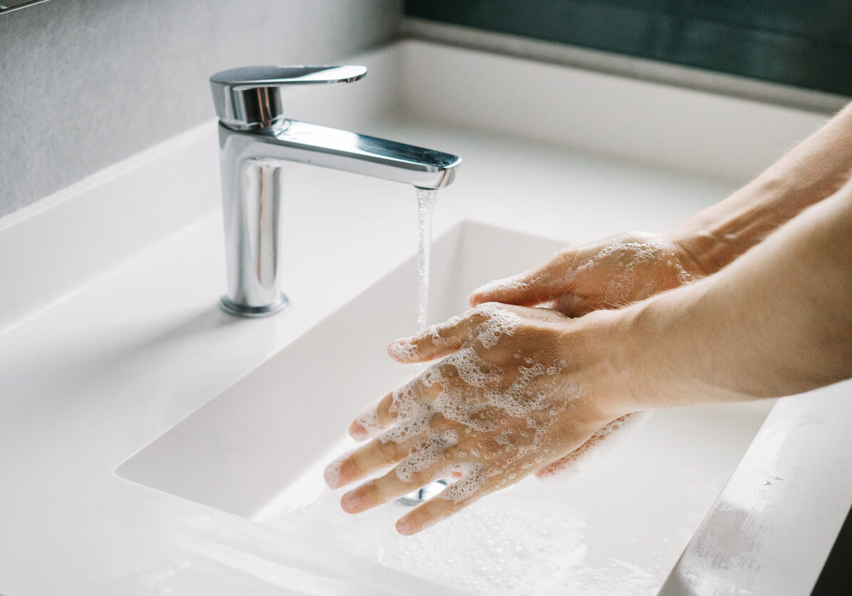 Man washing hands in the bathroom