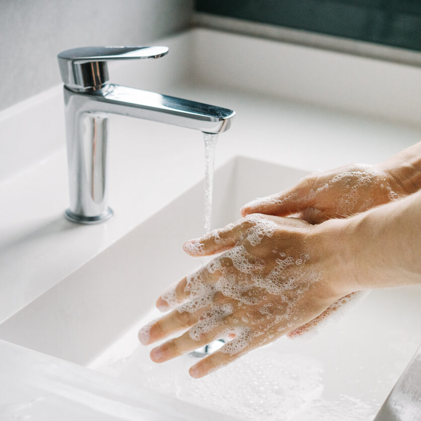 Man washing hands in the bathroom